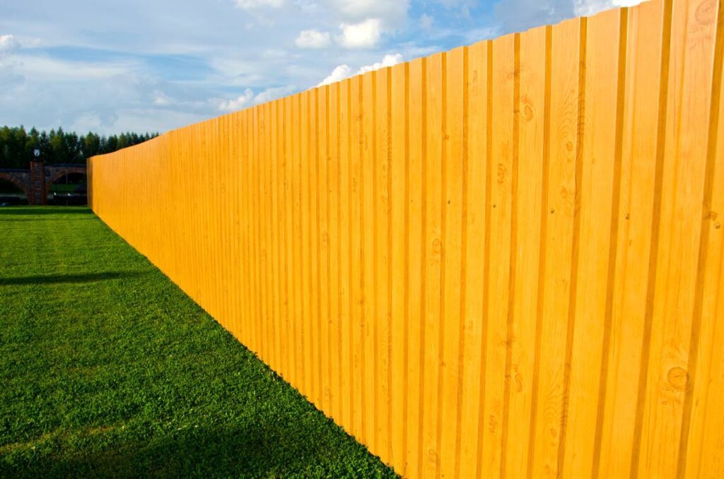 Yellow fence around a residential property