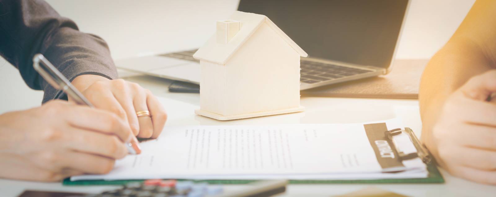 Signing divorce paperwork that includes the family home